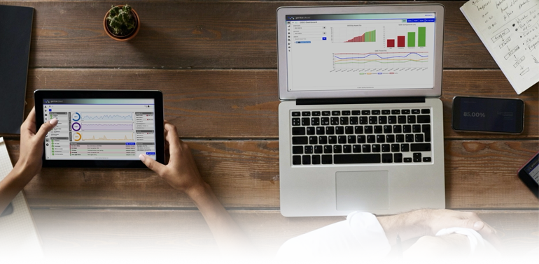 A tablet and a laptop displaying real-time data analytics on a wooden desk, symbolising digital connectivity and informed decision-making.