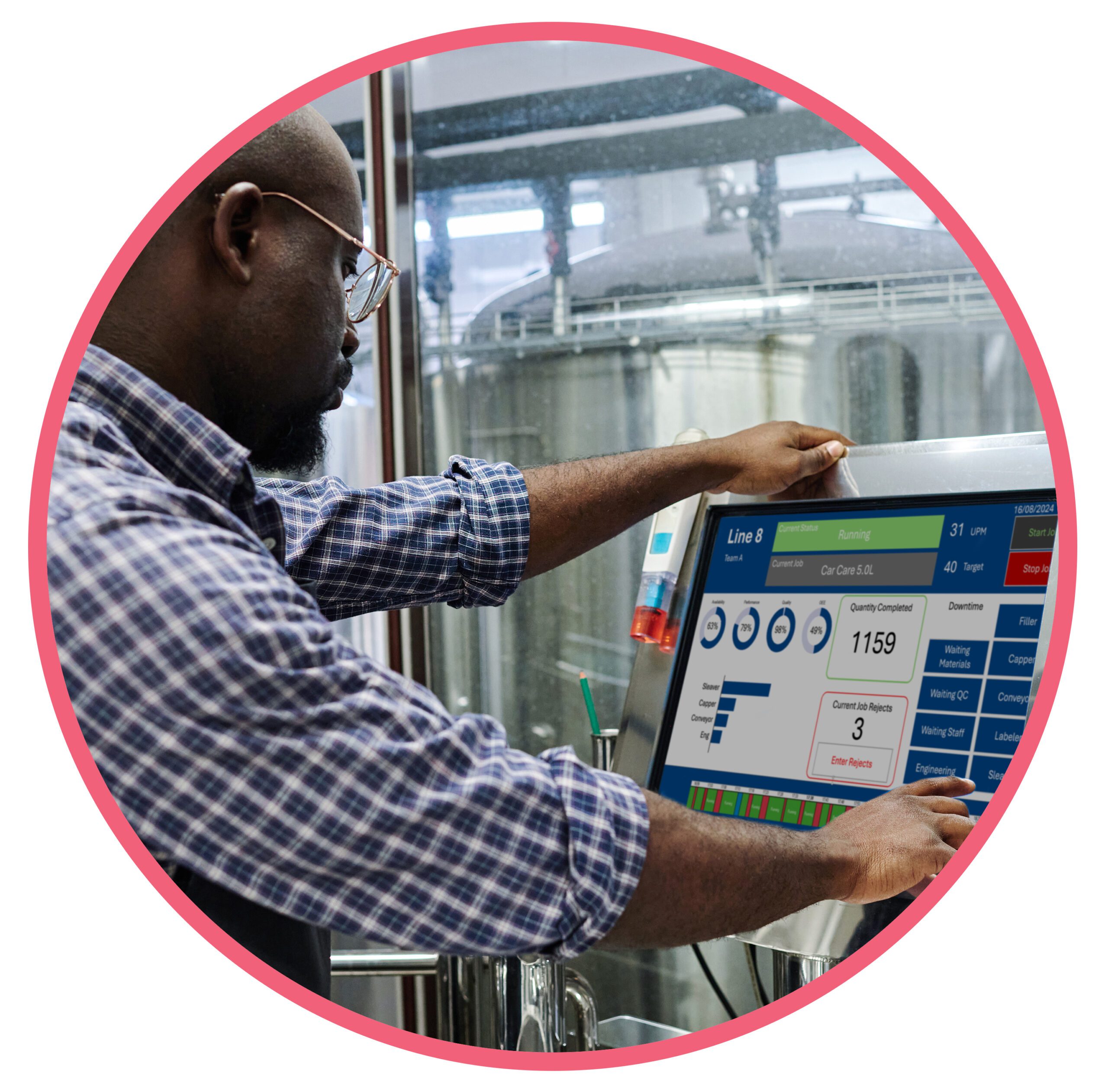 “Factory operator using a touchscreen display to track production and performance metrics