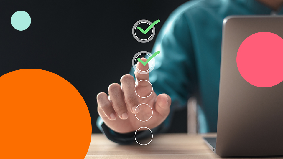 Person selecting checklist items on a digital interface next to a laptop.