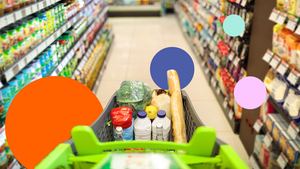 Shopping trolley filled with groceries in a supermarket aisle representing FMCG retail environment