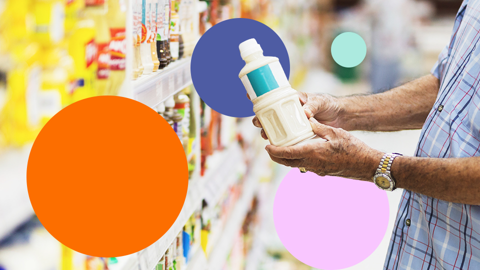 Customer reading a food product label in a supermarket aisle representing food safety and traceability.