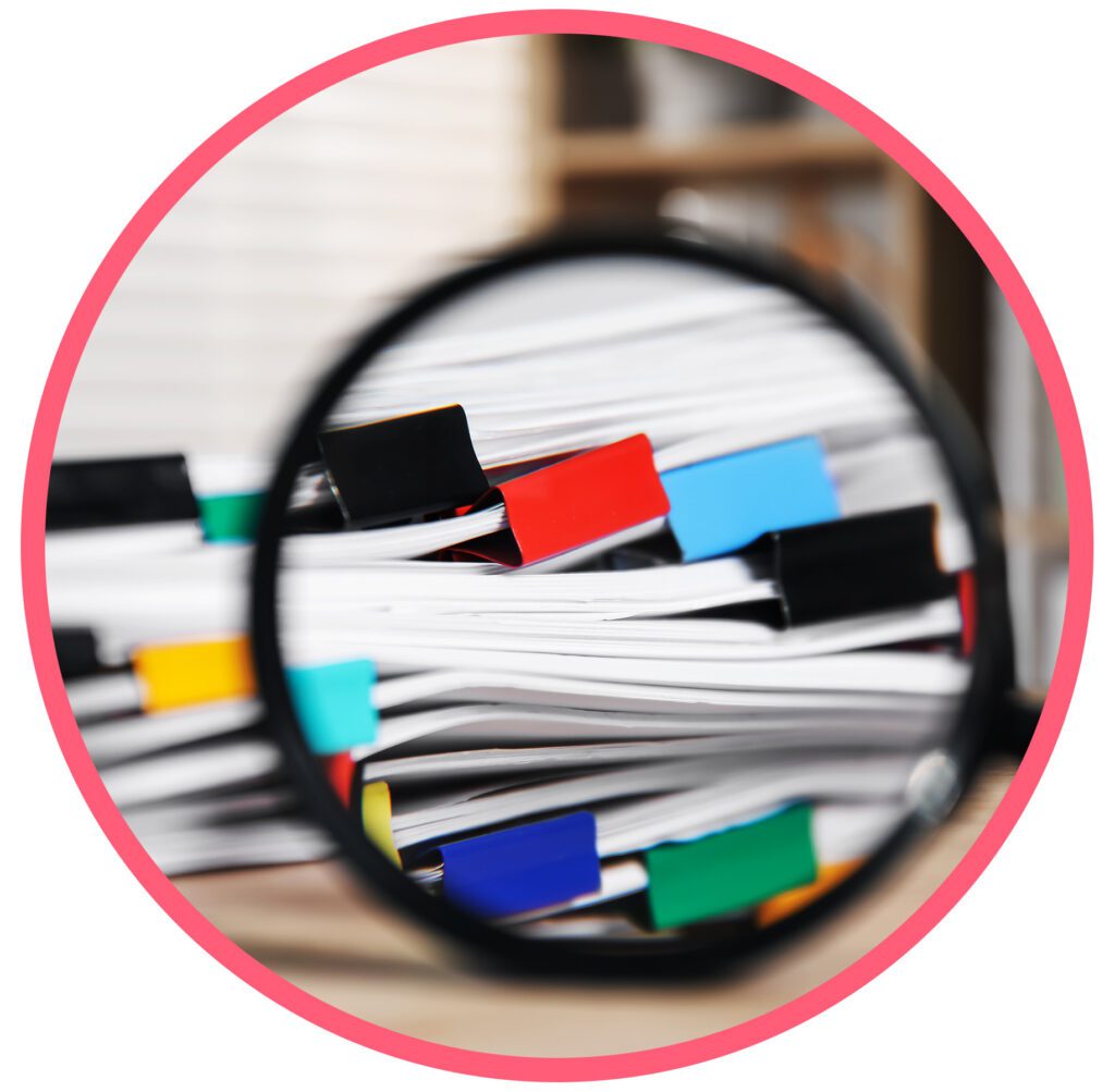 Magnifying glass over indexed manufacturing compliance documents and records