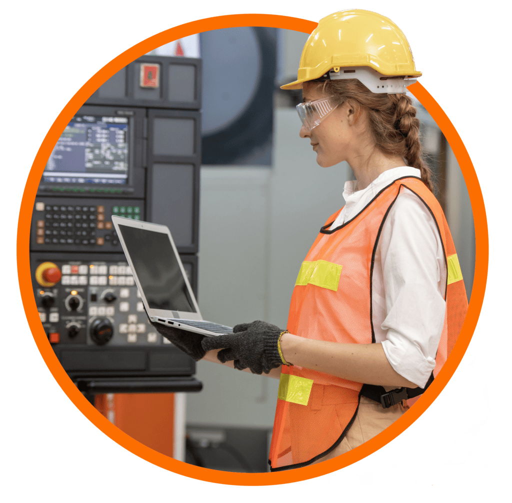 Manufacturing employee using digital technology to monitor production equipment